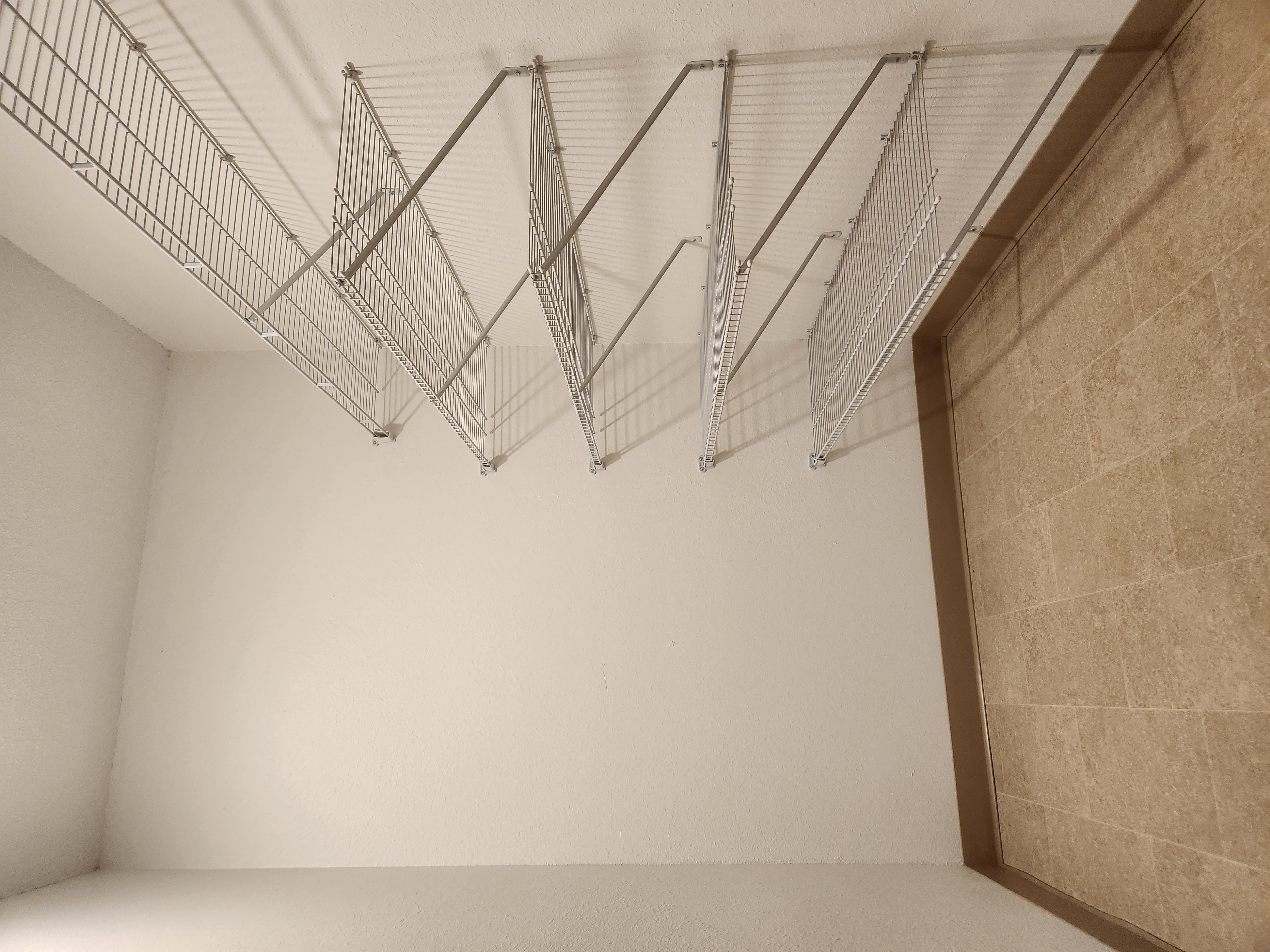 an empty room with metal bars hanging on the wall