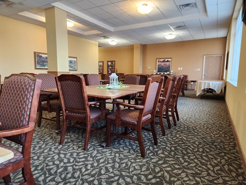 Community room with a table surrounded by chairs.
