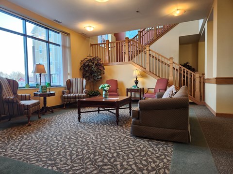 A living room with a staircase and a couch.