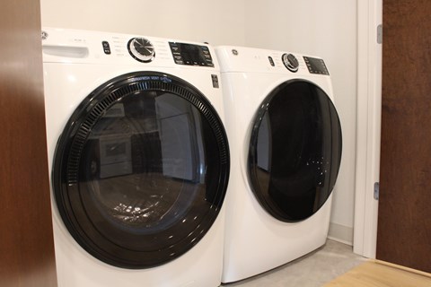A front load washing machine and dryer in a closet.