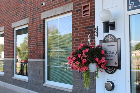 Front door of Brickyard Apartments with sign that says "Brickyard Apartments"