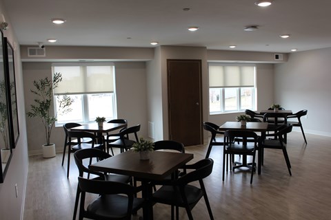 A dining room with a table and chairs.