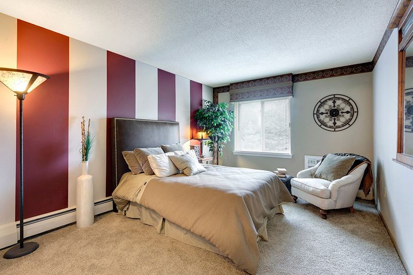 a bedroom with a bed and a chair