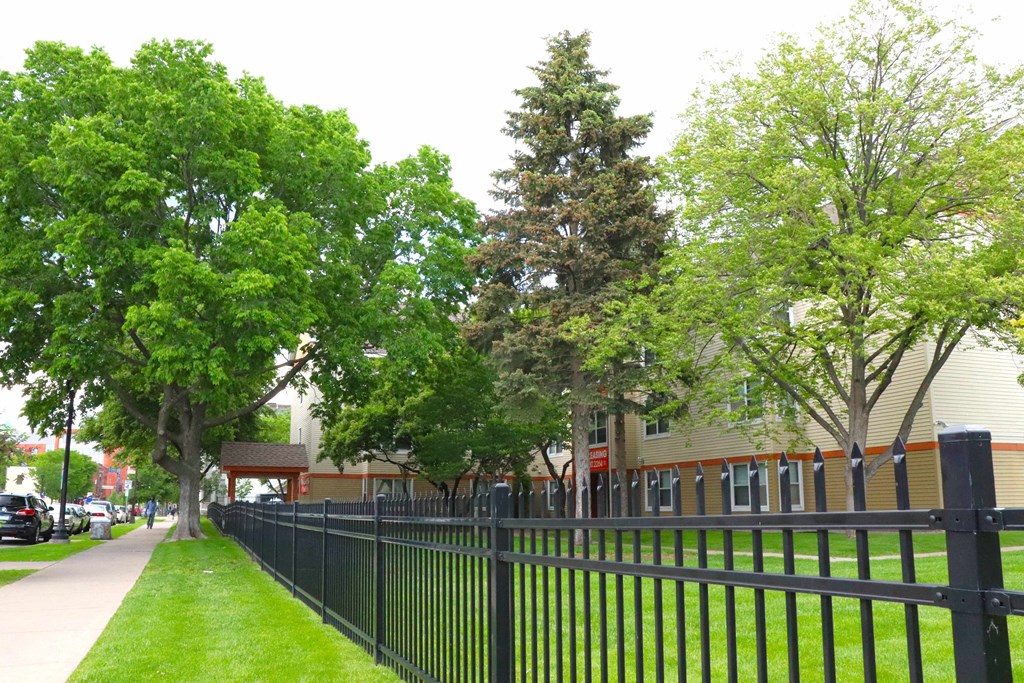 a black wrought iron fence in front of a school