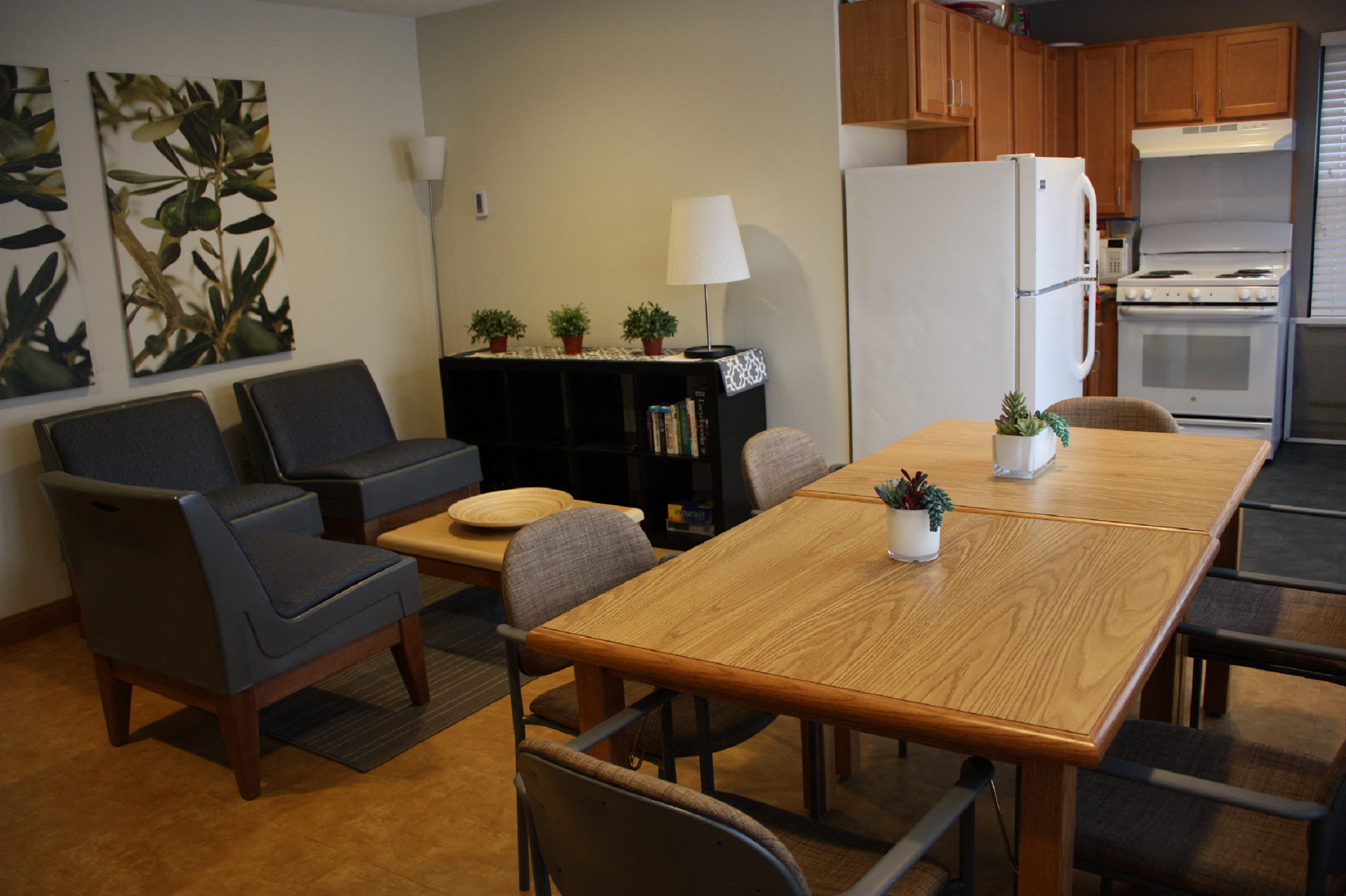 a kitchen and dining room with a wooden table and chairs