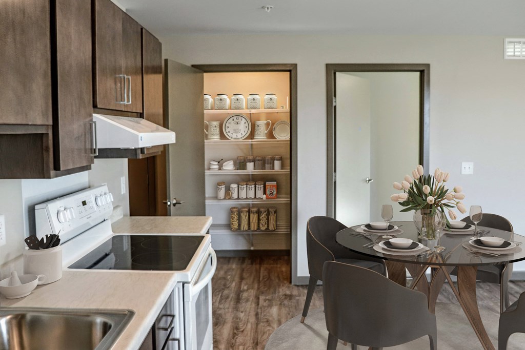 a kitchen and dining area leading to a pantry
