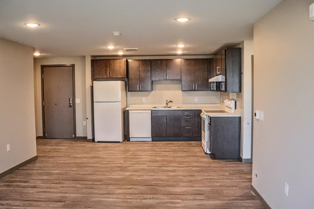 a kitchen with a white refrigerator freezer next to a dishwasher