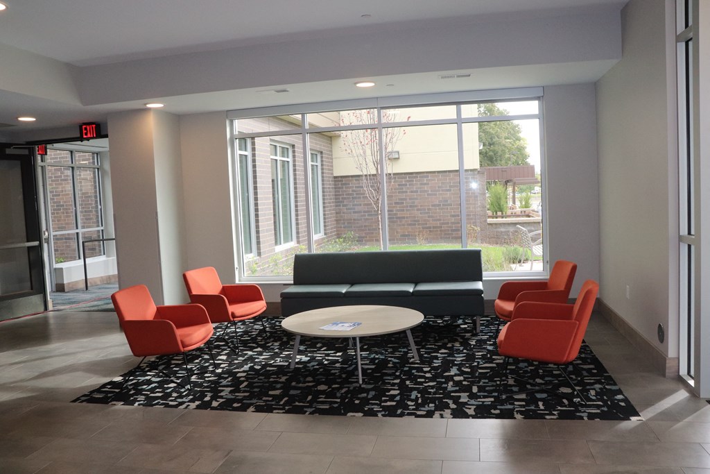 a lounge area with a couch and chairs and a coffee table