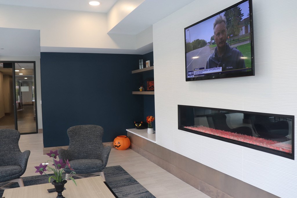 a living room with a tv and a table and chairs