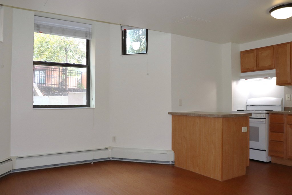 an empty kitchen with an island and a window