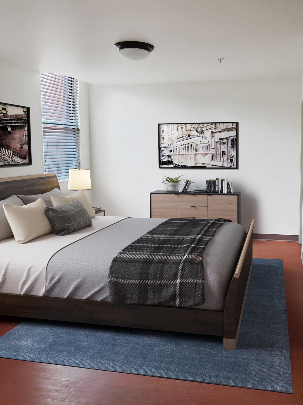 a bedroom with a bed with a blanket and pillows