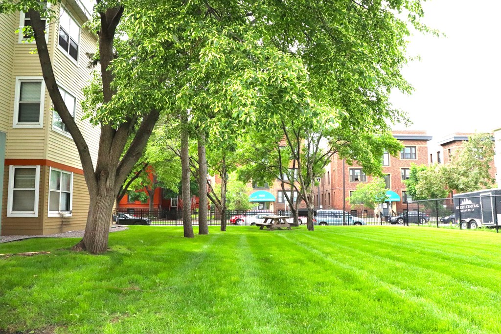 a lush green lawn in front of a apartment building