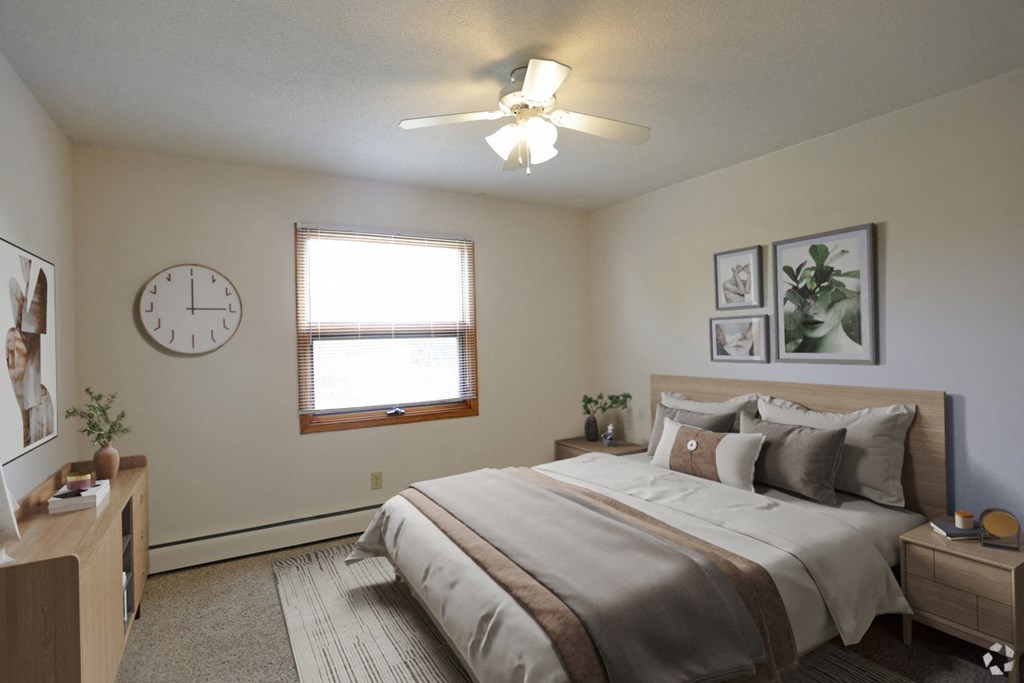 a bedroom with a large bed and a clock on the wall