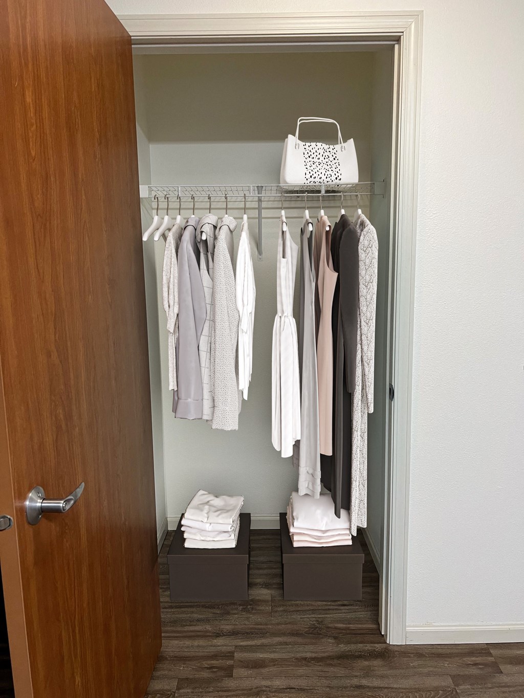 a walk in closet with a wooden door and two wooden boxes on the floor