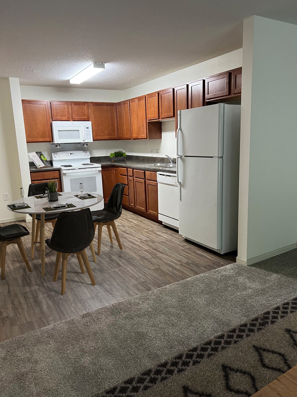 a kitchen with white appliances and wooden cabinets