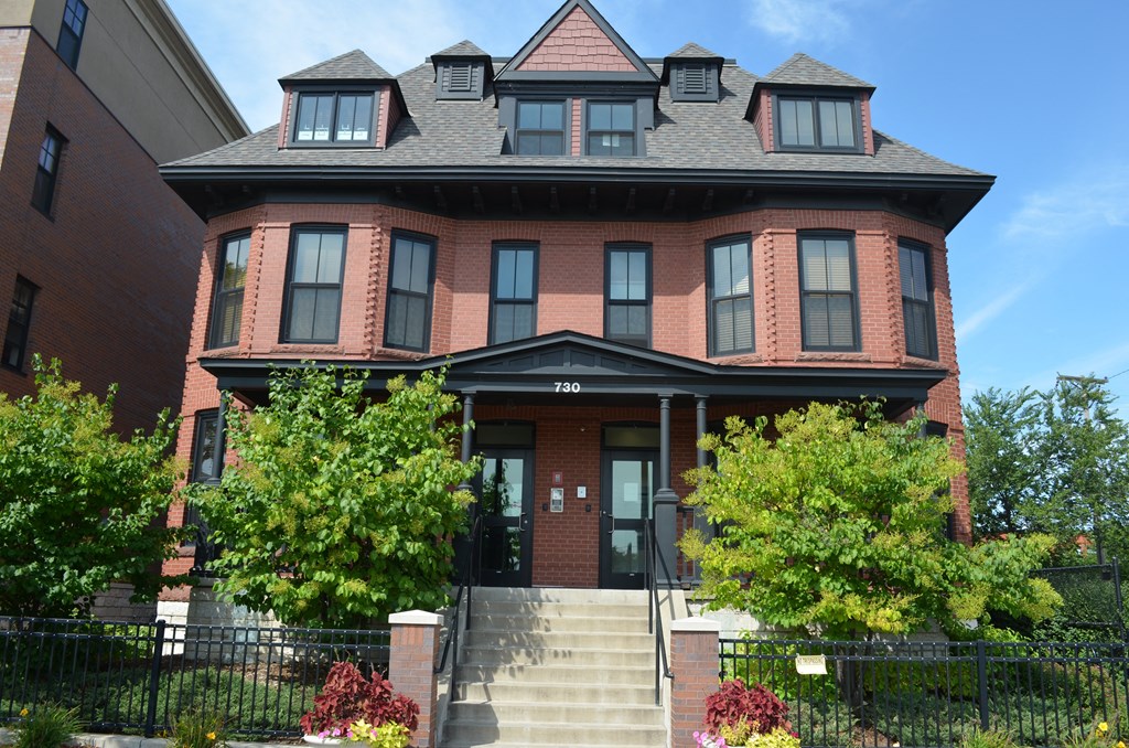 a large brick house with stairs in front of it