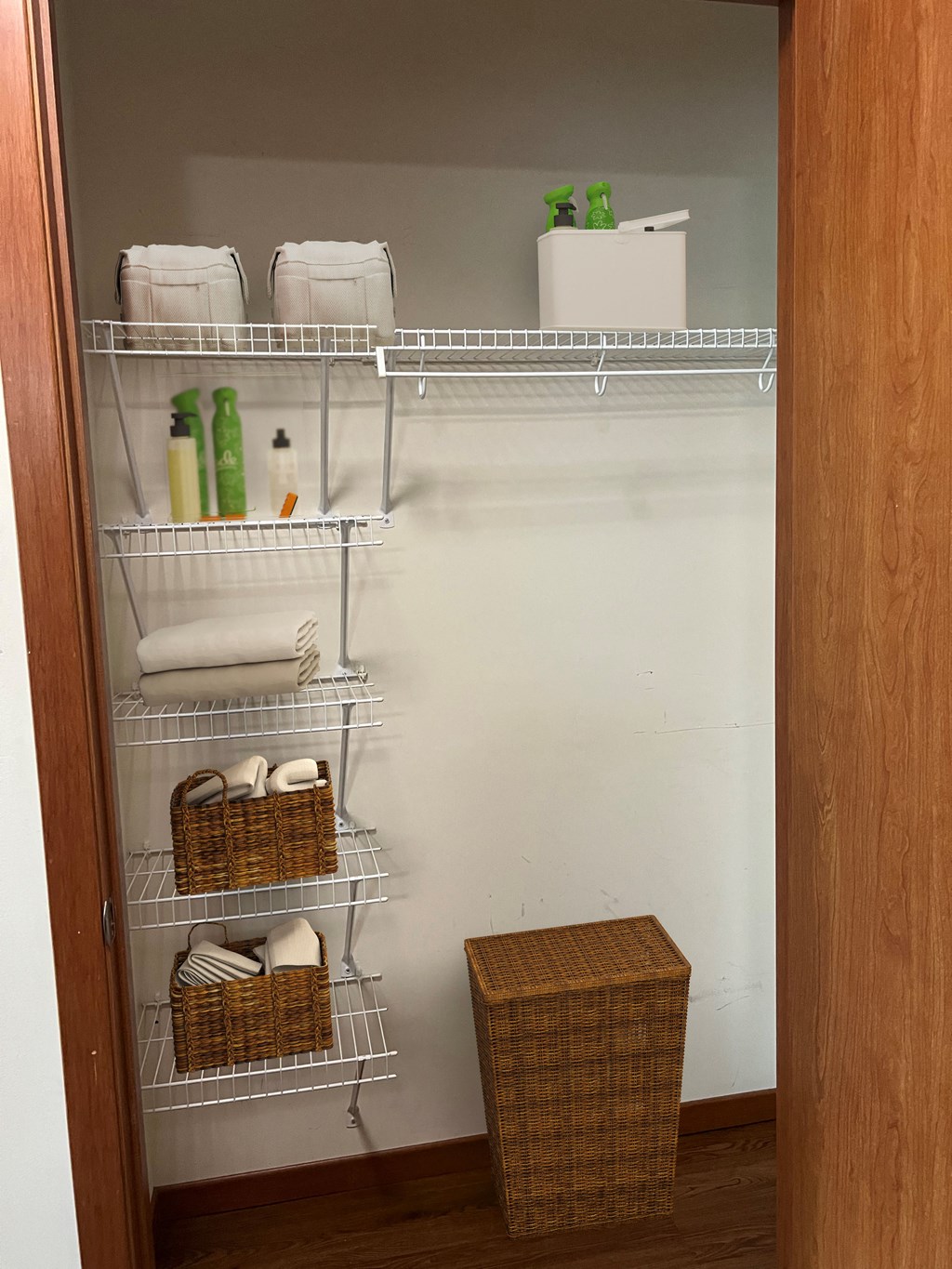 an empty closet with towels and baskets in it