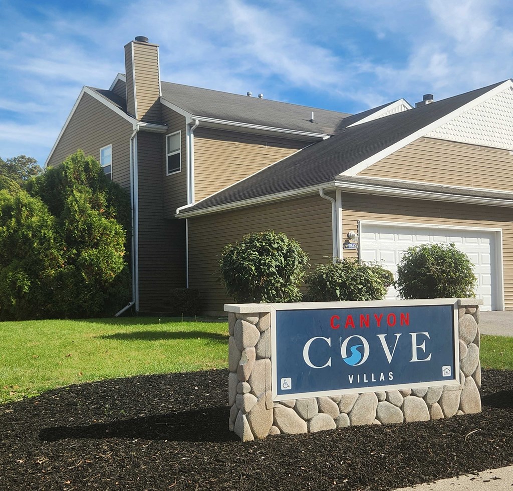a sign in front of a house that reads canyon cove villas