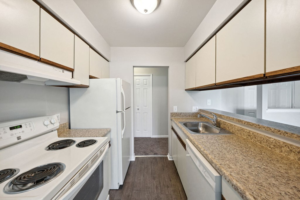 a kitchen with white appliances and granite counter tops