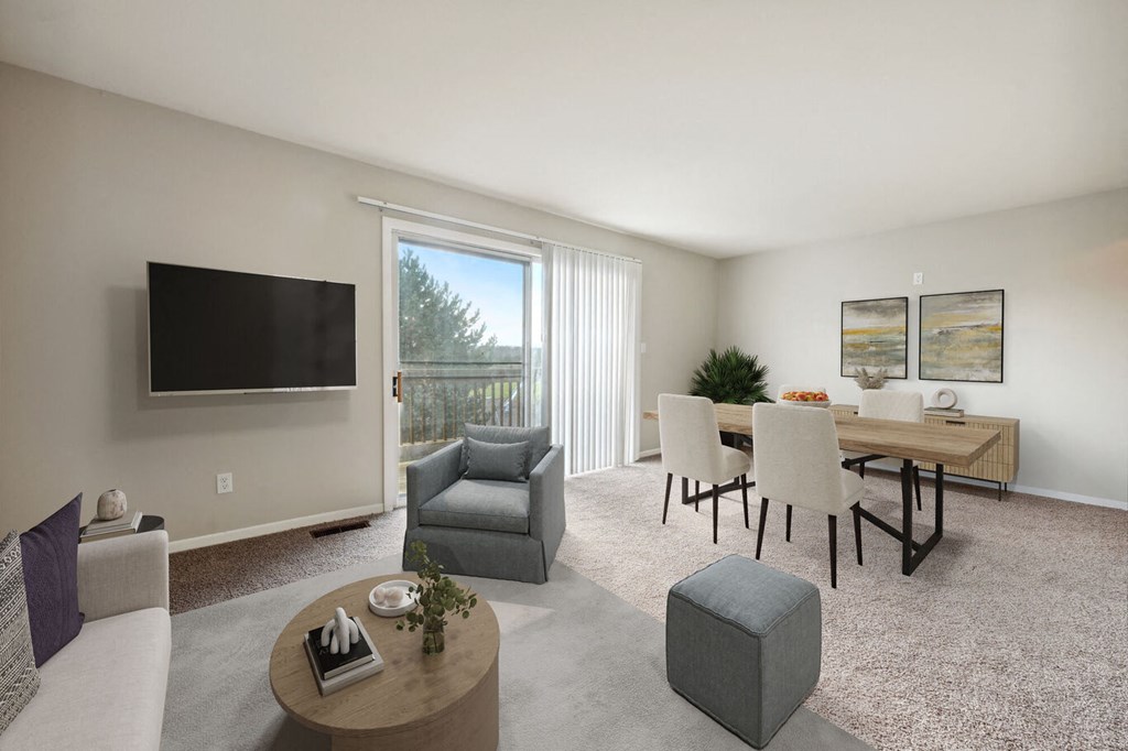a living room and dining room with a table and a television