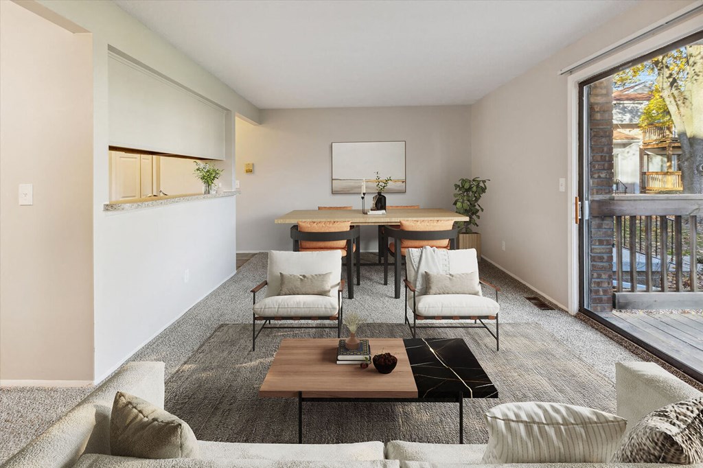 a living room with a couch and chairs and a table