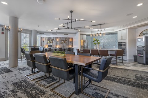 A modern dining room with a large table and chairs.