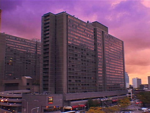 A large building with many windows is in the foreground.