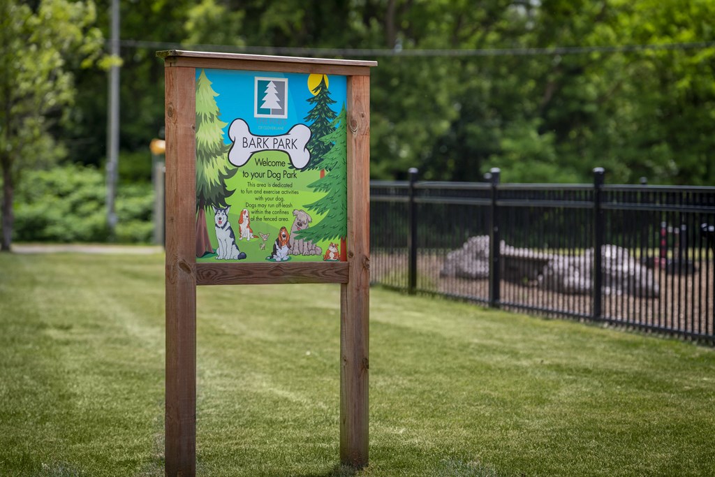 a sign in the middle of a grass field
