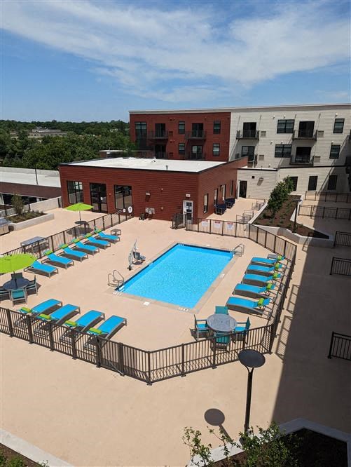 an aerial view of a swimming pool and a building