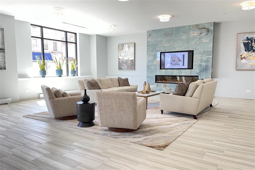 a living room with couches and chairs and a fireplace