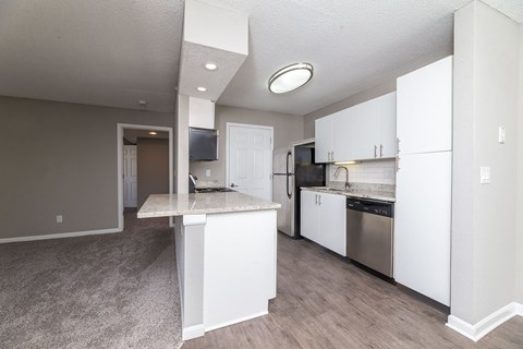 a renovated kitchen with white cabinets and stainless steel appliances