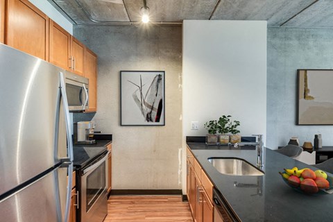 a kitchen with stainless steel appliances and wooden cabinets