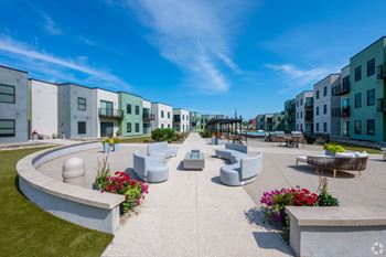 A sunny day at a modern residential area with apartment buildings and a communal garden.