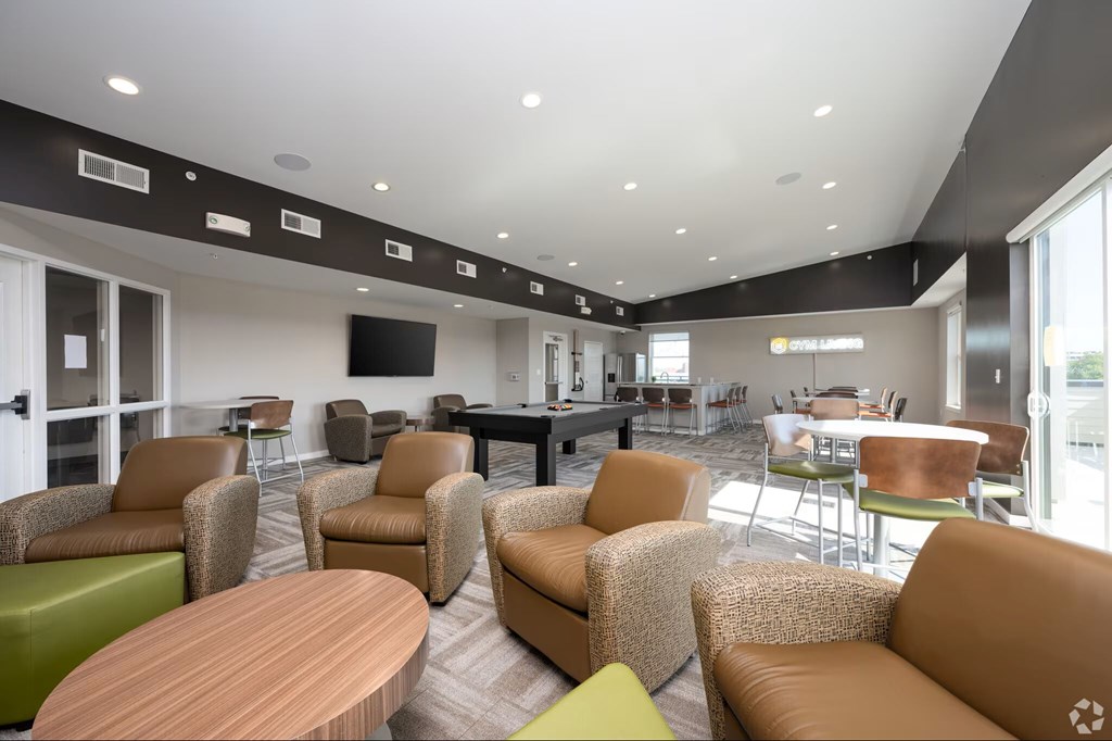 A modern lounge area with brown and green furniture.