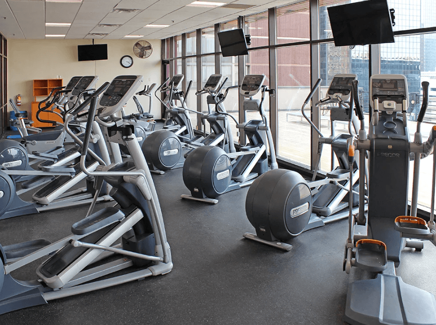 A gym with treadmills, elliptical machines, and other cardio equipment.