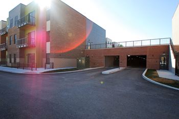 A sunny day at the parking lot of a modern building.