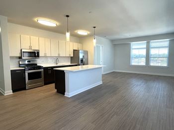 an empty kitchen with an island in the middle