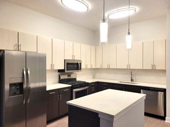 a kitchen with stainless steel appliances and white counter tops