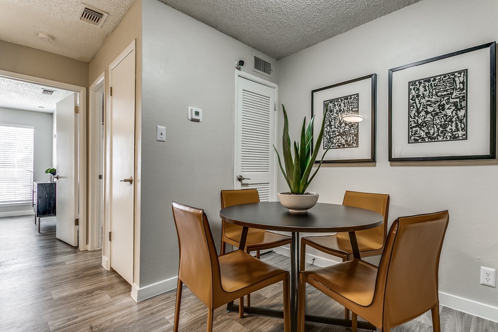 a dining room with a table and chairs