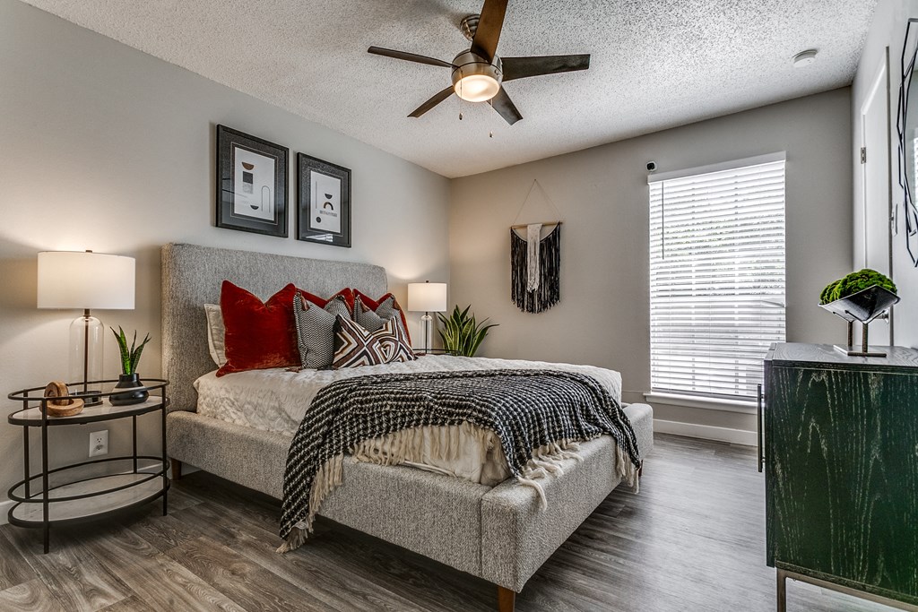 a bedroom with a bed and a ceiling fan