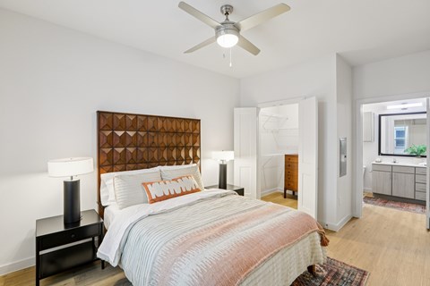 Bedroom with geometric headboard and ceiling fan at Matador Apartments, Austin, TX 78745