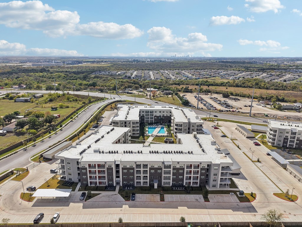 A large white building with a pool in the middle of it.