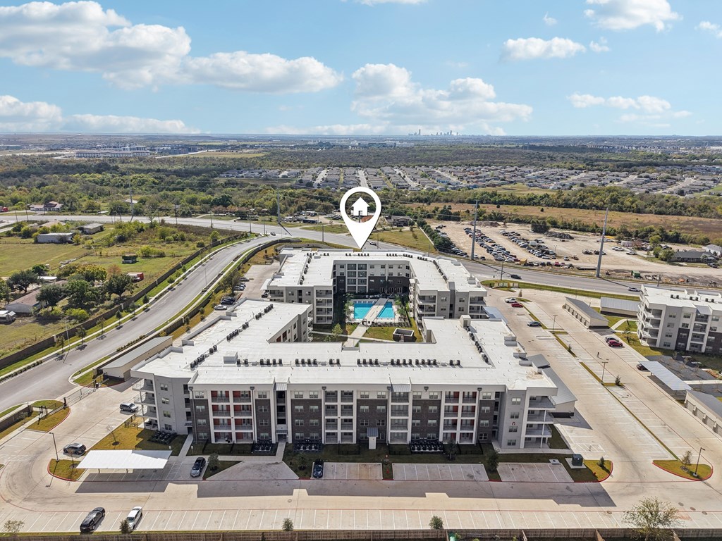 A large white building with a pool in the middle of it.