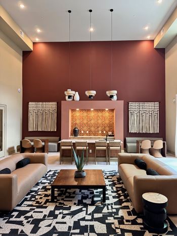A living room with a brown wall and a black and white rug.