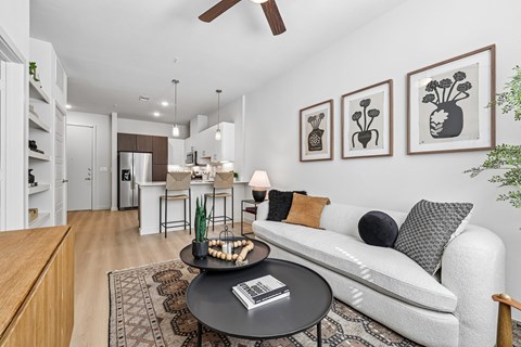 A living room with a white couch and a coffee table with a book on it.