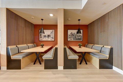 A modern dining room with a long table and chairs.