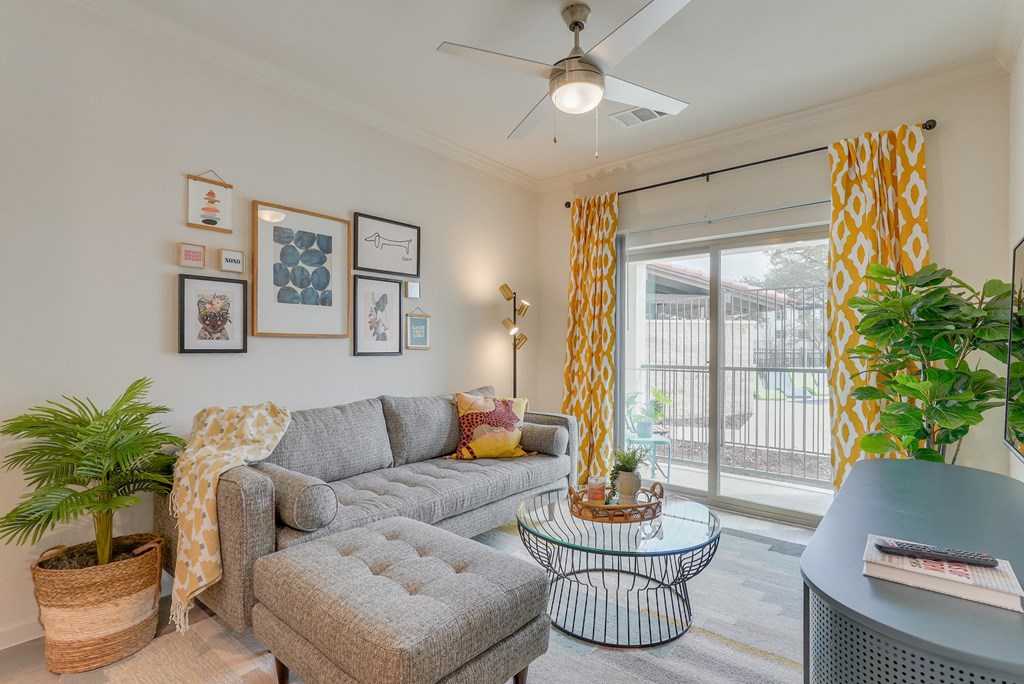 a living room with a couch and a table and a sliding glass door