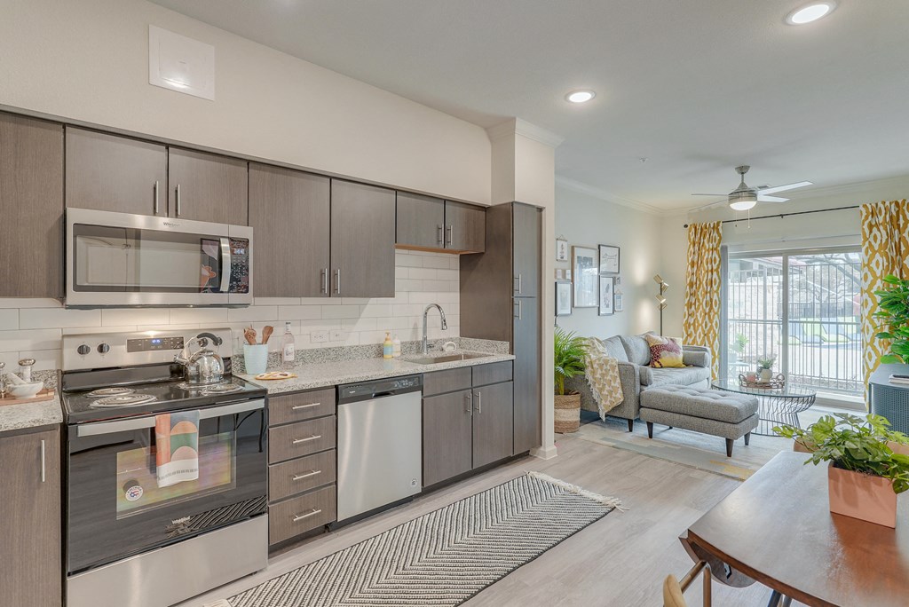 an open kitchen and living room with a large window