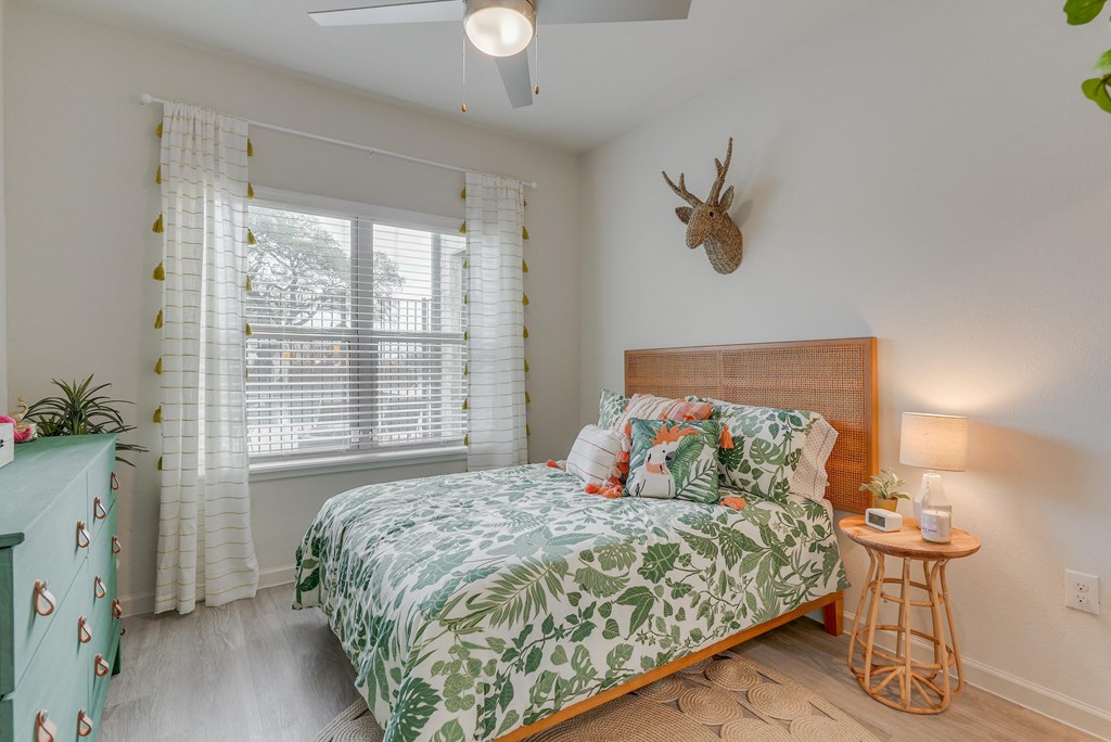 a bedroom with a bed and a deer head on the wall