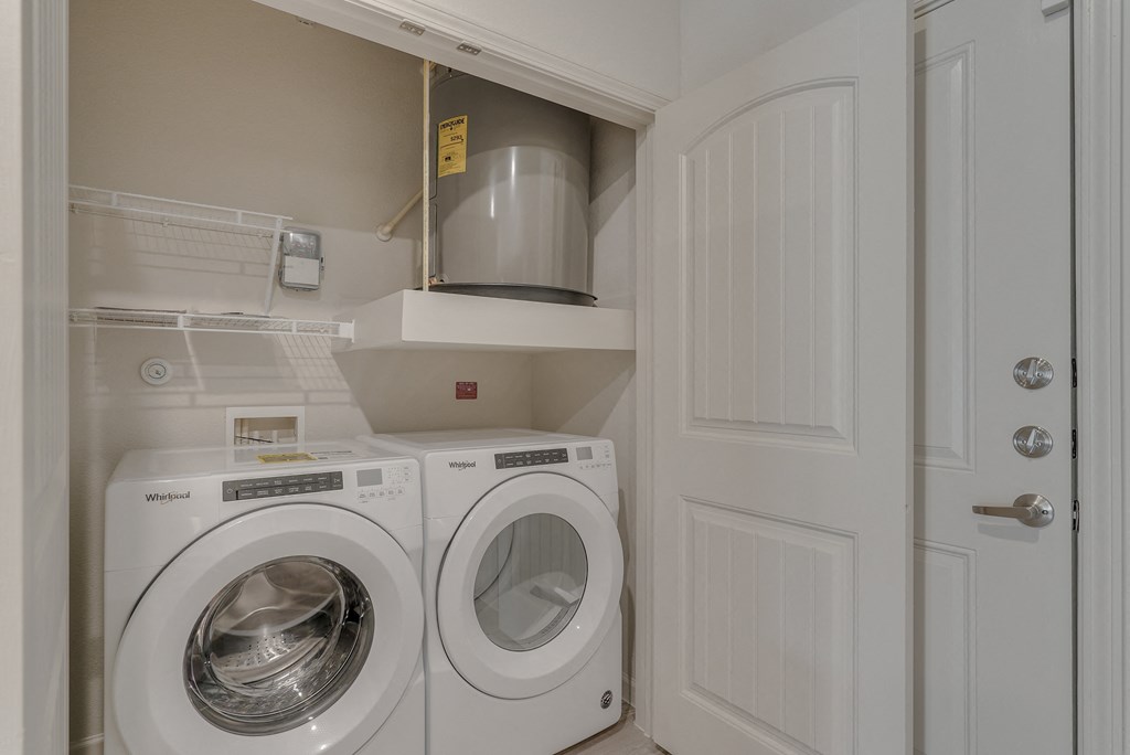 a washer and dryer in a laundry room with a white door